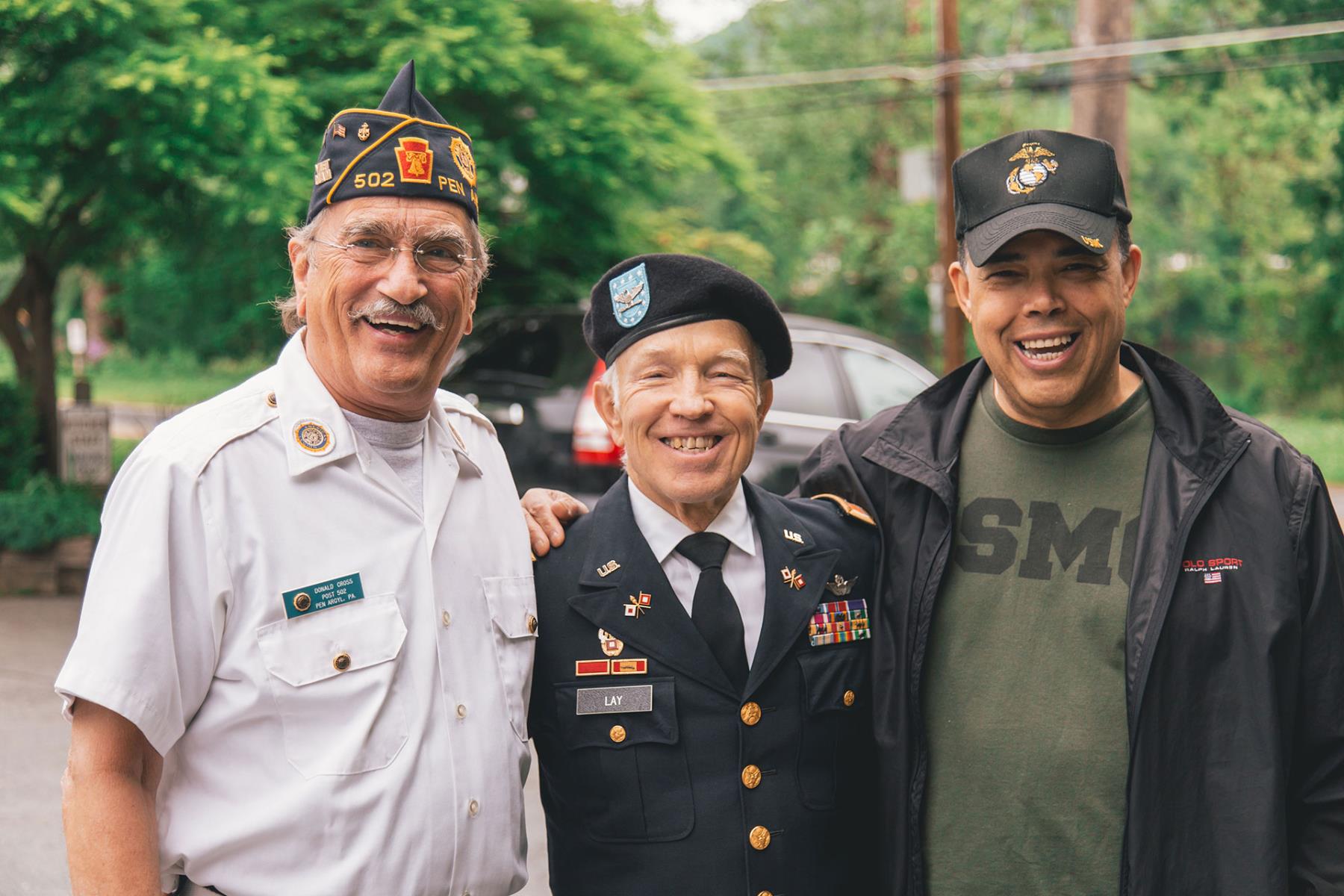 Three male veterans smiling at the camera